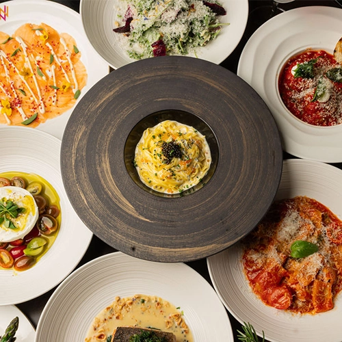 Wevino Dining Room Set For Dinner With Wine Glasses, Ambient Lighting, And Elegant Modern Italian Decor In Westlake Village.