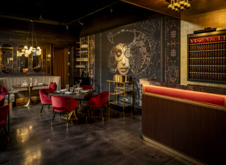 WeVINO dining room with red booths and a mosaic feature wall