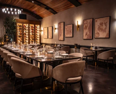 Long communal dining table under the vaulted wood ceiling at WeVINO