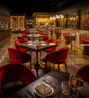 WeVINO dining room with red upholstered chairs and an illuminated wine display
